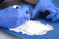 Templating and cutting the first ply of prepreg